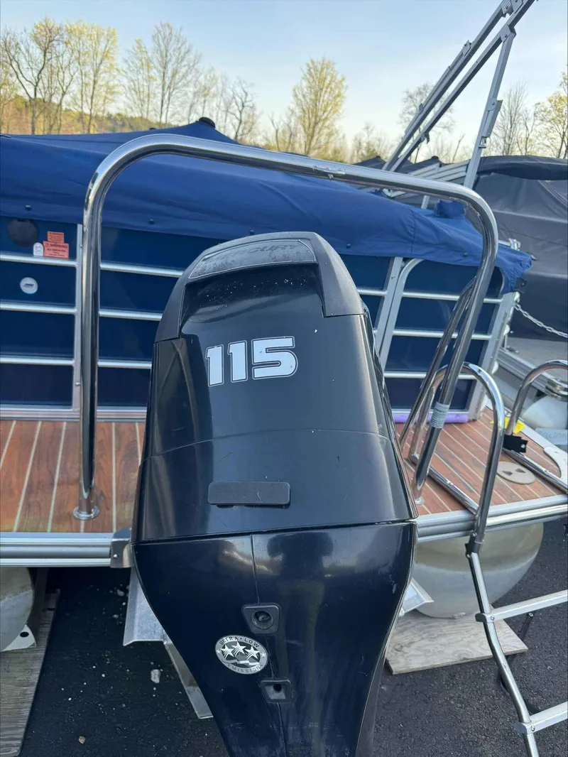 Slide: The Image of 2013 Berkshire 230CL STS boat with 115 horsepower outboard motor, docked with cover. - 4