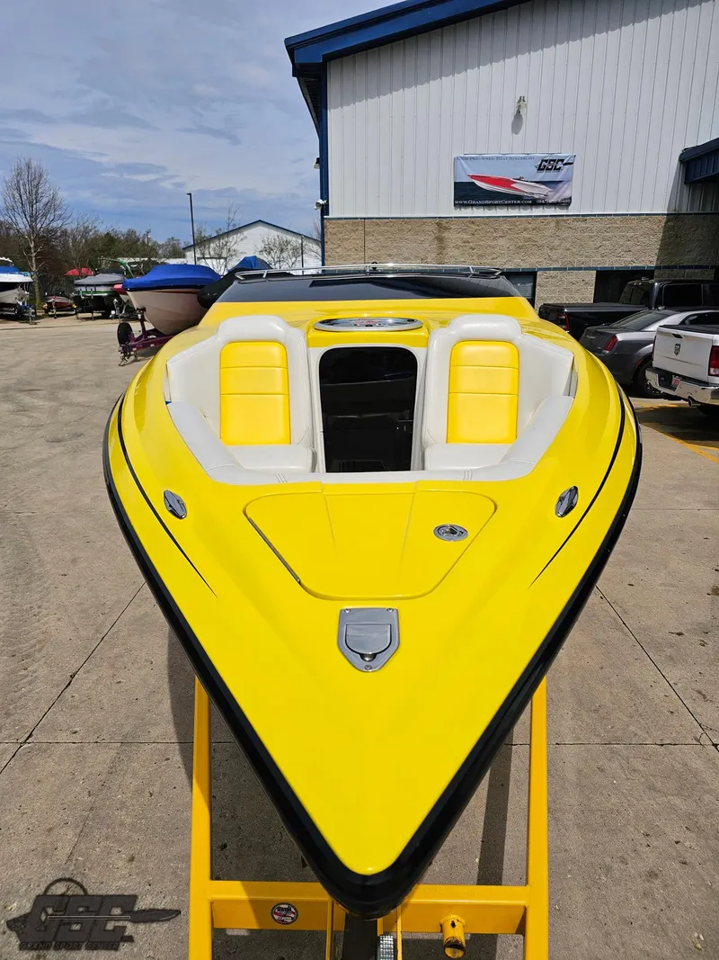 Slide: The Image of 2006 Advantage 28 Victory Bowrider, vibrant yellow, parked outdoors at a marina. - 12