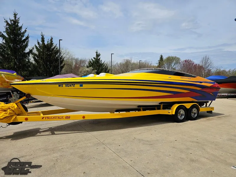 Slide: The Image of 2006 Advantage 28 Victory Bowrider in vibrant yellow with trailer, parked outdoors. - 15