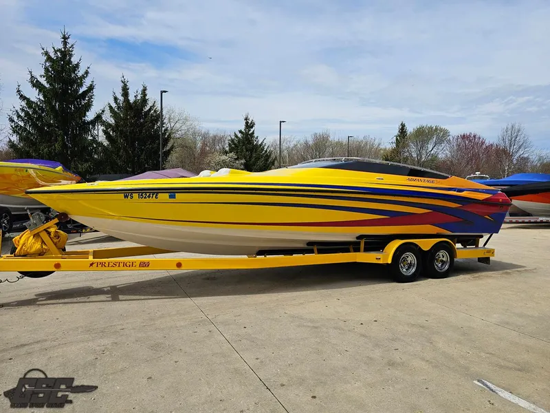Slide: The Image of 2006 Advantage 28 Victory Bowrider in yellow with vibrant stripes on a trailer. - 16