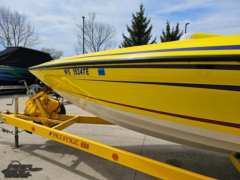Slide: The Image of Yellow 2006 Advantage 28 Victory Bowrider on trailer, parked outdoors. - 17