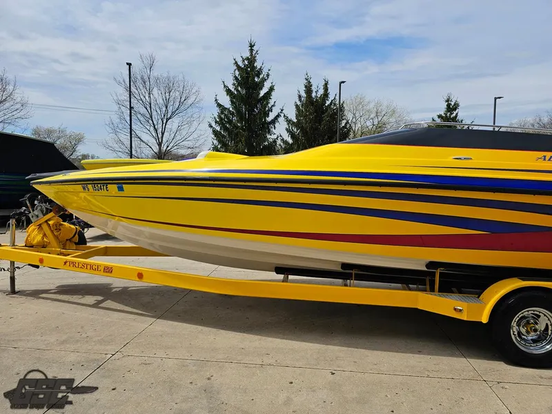Slide: The Image of 2006 Advantage 28 Victory Bowrider in vibrant yellow with blue and red stripes on trailer. - 18