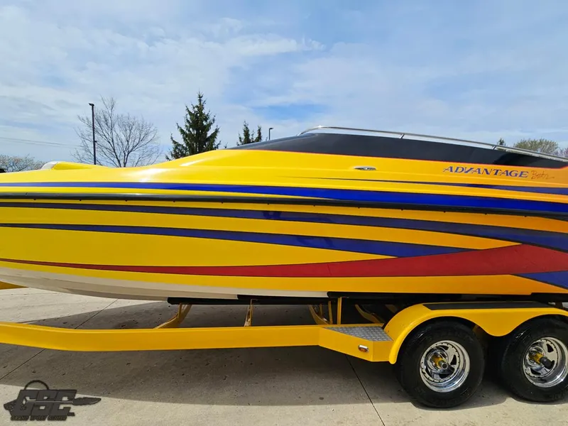 Slide: The Image of 2006 Advantage 28 Victory Bowrider, yellow with vibrant stripes, on a matching trailer. - 20
