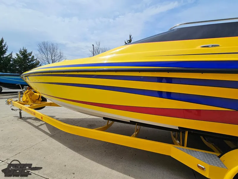 Slide: The Image of 2006 Advantage 28 Victory Bowrider in vibrant yellow with blue and red stripes on trailer. - 21