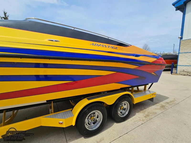 Slide: The Image of 2006 Advantage 28 Victory Bowrider with vibrant yellow, blue, and red design on a trailer. - 22