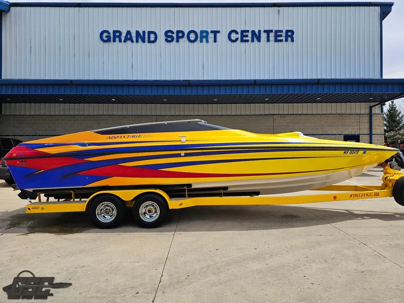 Slide: The Image of 2006 Advantage 28 Victory Bowrider boat with vibrant yellow and blue design at Grand Sport Center. - 3
