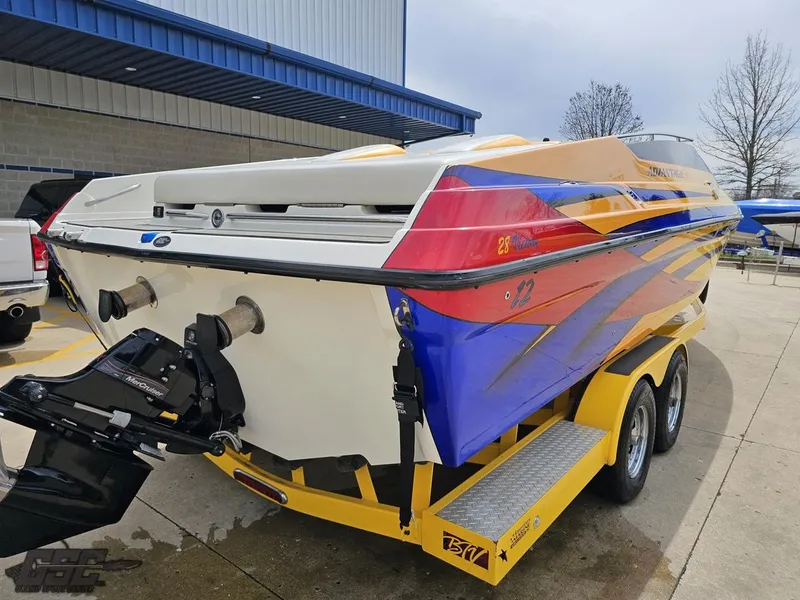 Slide: The Image of 2006 Advantage 28 Victory Bowrider boat on a yellow trailer, vibrant blue and orange design. - 31