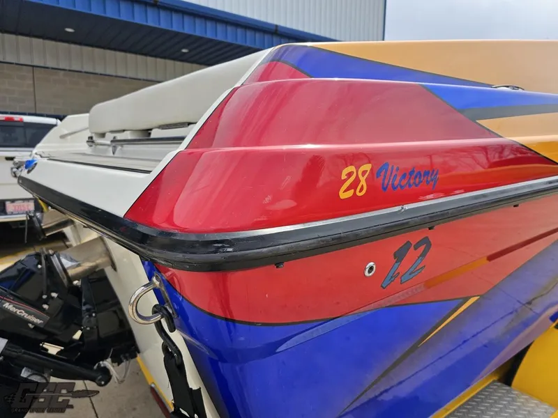 Slide: The Image of 2006 Advantage 28 Victory Bowrider with vibrant red, blue, and yellow design. - 32