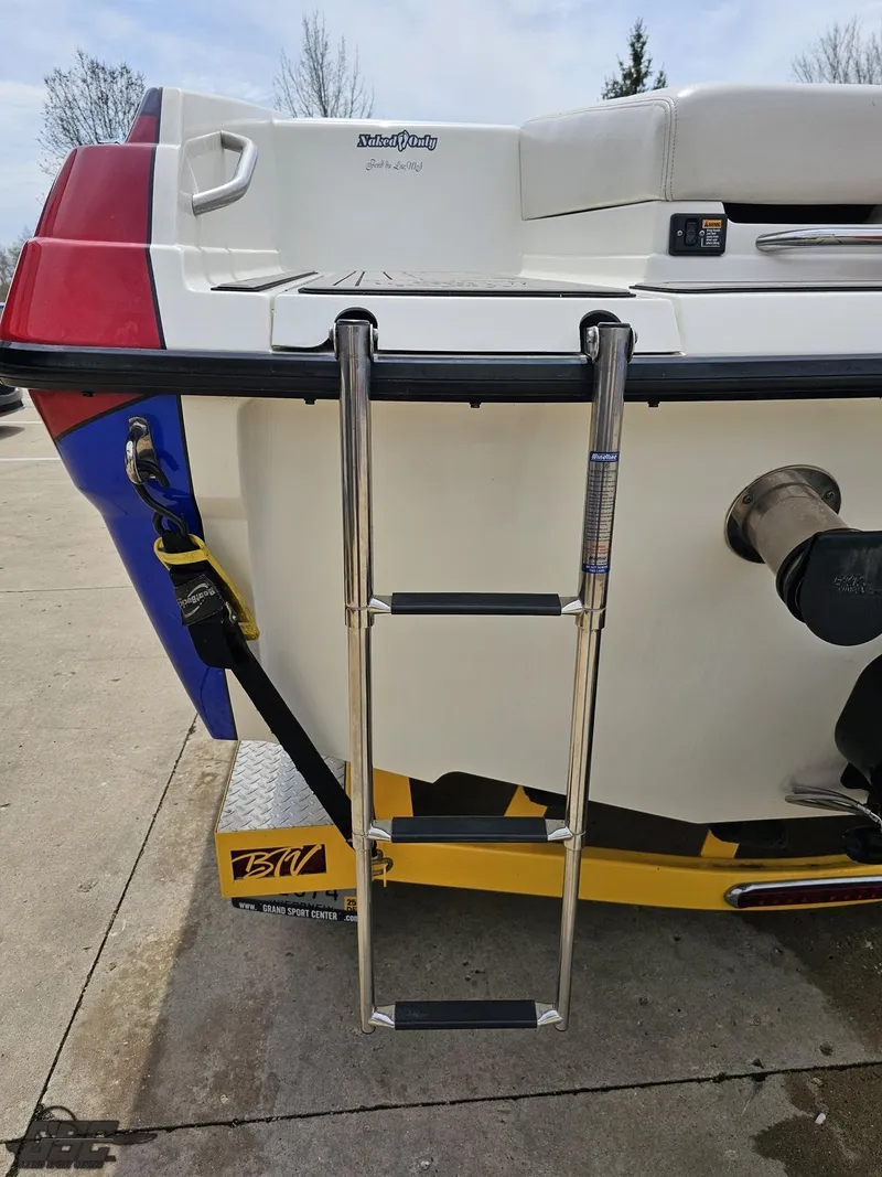 Slide: The Image of 2006 Advantage 28 Victory Bowrider with ladder and trailer, parked on concrete. - 36