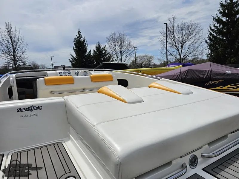 Slide: The Image of 2006 Advantage 28 Victory Bowrider with white and yellow seating, parked outdoors. - 38