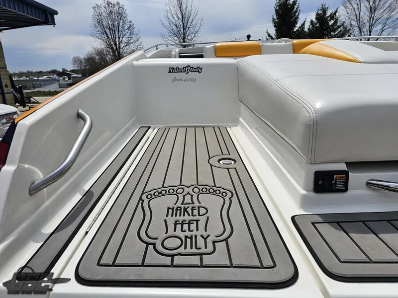 Slide: The Image of 2006 Advantage 28 Victory Bowrider with "Naked Feet Only" deck mat, white and yellow seating. - 39