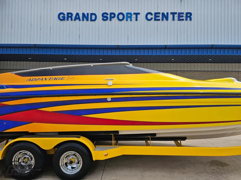 Slide: The Image of 2006 Advantage 28 Victory Bowrider, yellow with colorful stripes, at Grand Sport Center. - 4