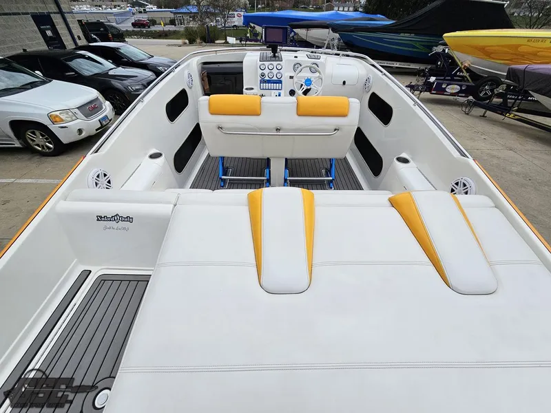 Slide: The Image of 2006 Advantage 28 Victory Bowrider boat with white and yellow seating, docked outdoors. - 44