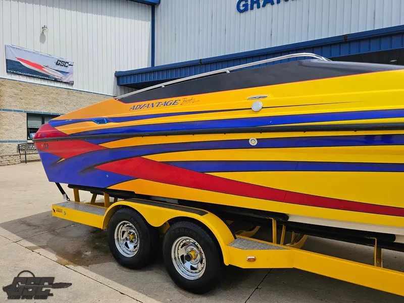Slide: The Image of 2006 Advantage 28 Victory Bowrider with vibrant yellow, red, and blue design on trailer. - 6