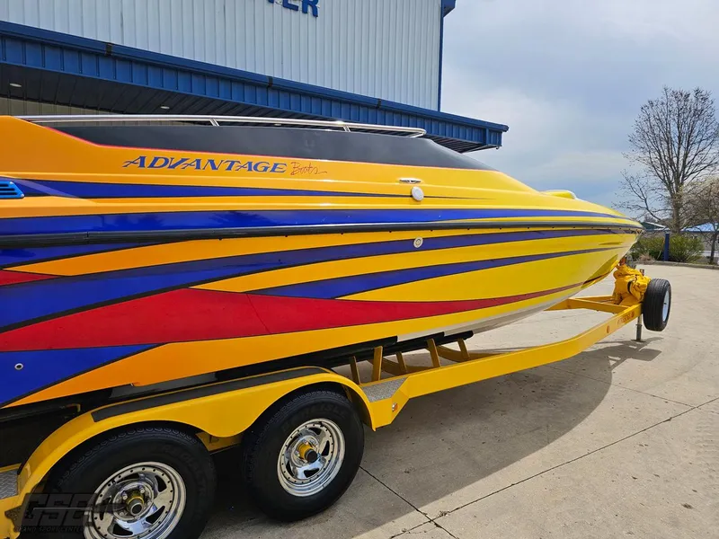 Slide: The Image of 2006 Advantage 28 Victory Bowrider in vibrant yellow with blue and red accents on trailer. - 9
