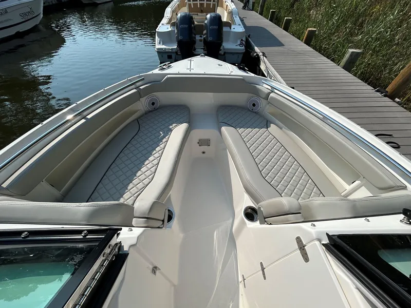Slide: The Image of 2026 Pursuit DC 266 Dual Console boat interior with cushioned seating and sleek design. - 15