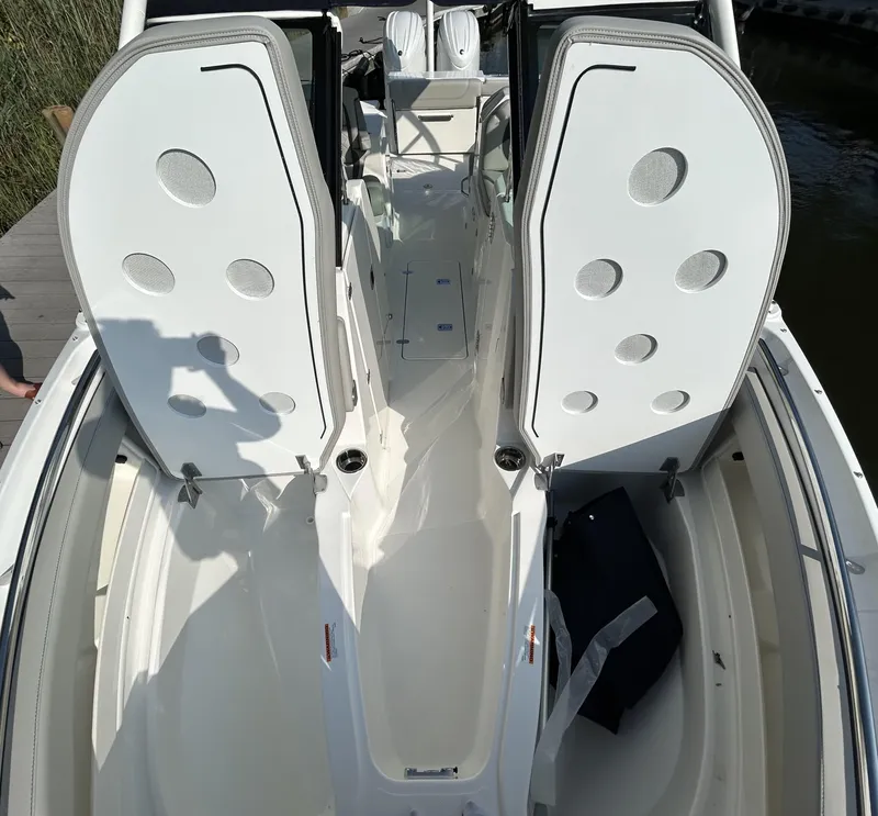 Slide: The Image of 2026 Pursuit DC 266 Dual Console boat interior with open seating and storage compartments. - 16
