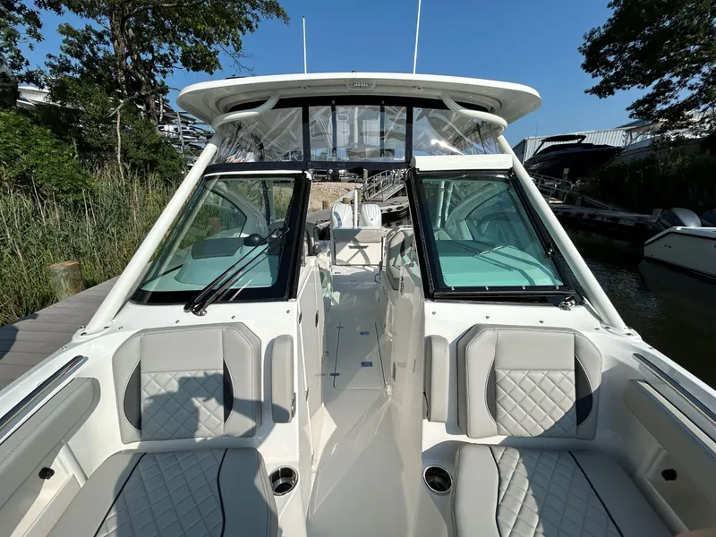 Slide: The Image of 2026 Pursuit DC 266 Dual Console boat with sleek design and comfortable seating. - 18