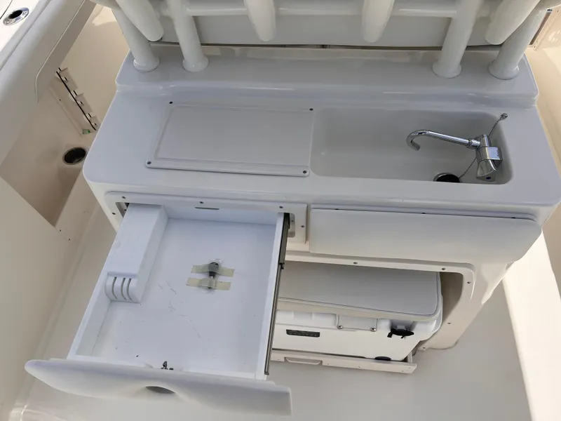 Slide: The Image of 2025 Key West 260 CC boat interior with sink and storage compartments. - 11