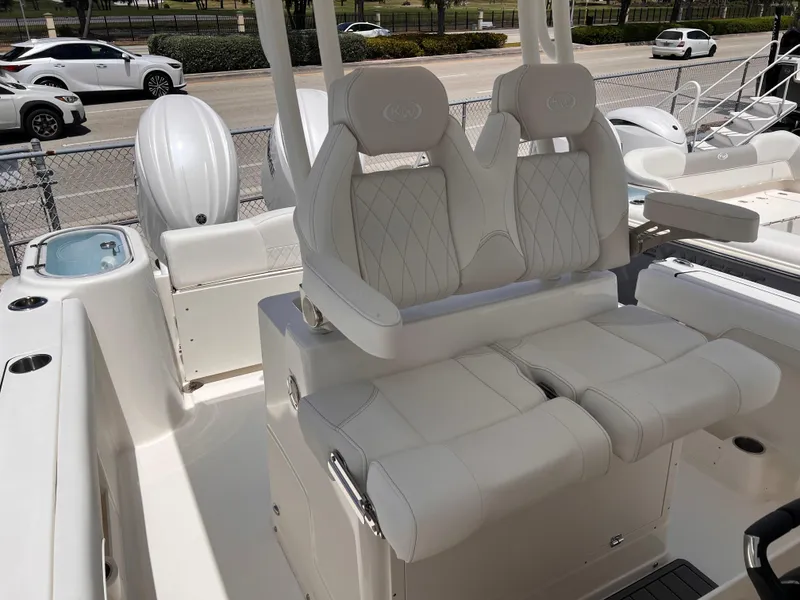 Slide: The Image of 2025 Key West 260 CC boat interior with white cushioned seating and modern design. - 14