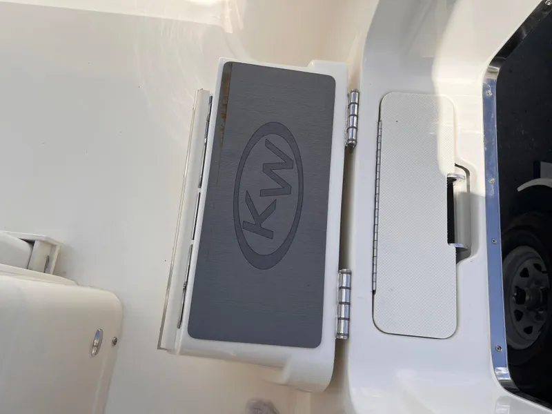 Slide: The Image of 2025 Key West 260 CC boat interior with KW logo on a hinged compartment. - 15
