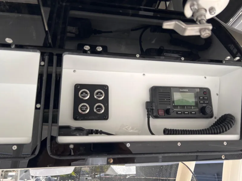 Slide: The Image of 2025 Key West 260 CC boat dashboard with radio and control panel. - 17