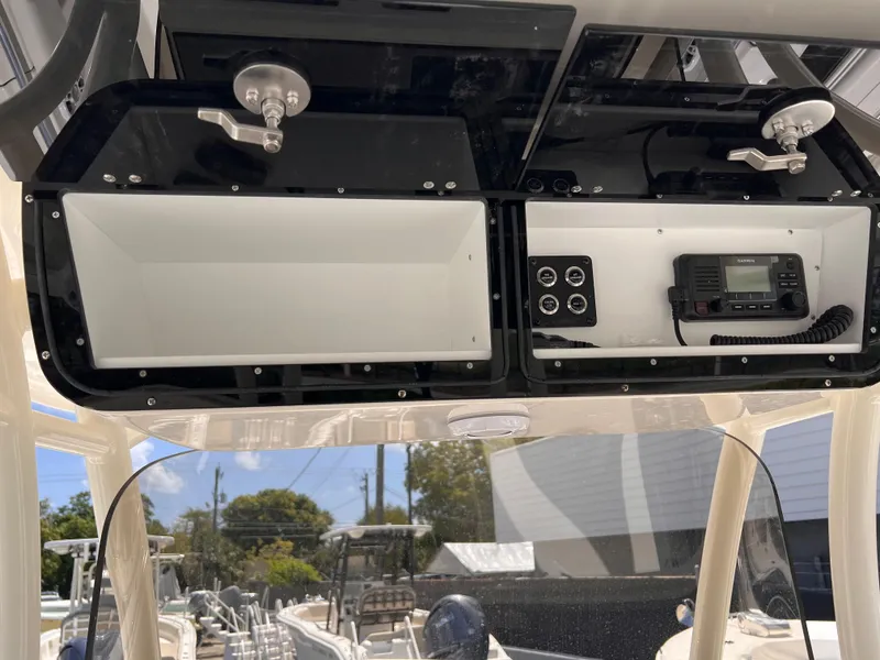 Slide: The Image of 2025 Key West 260 CC boat console with storage and communication equipment. - 18