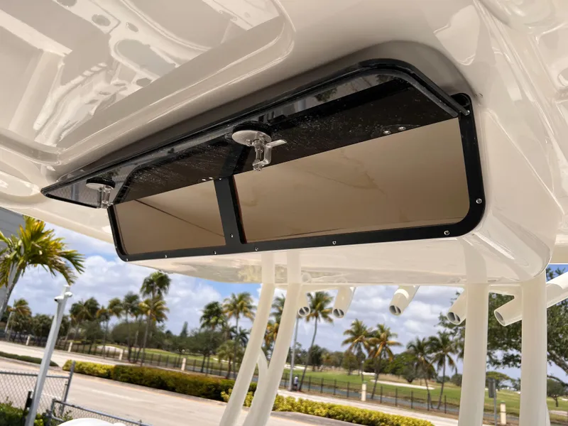 Slide: The Image of 2025 Key West 260 CC boat storage compartment with tropical background. - 19