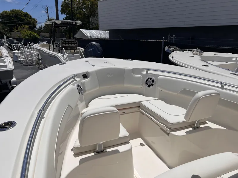 Slide: The Image of 2025 Key West 260 CC boat with white seating and sleek design in a marina setting. - 21