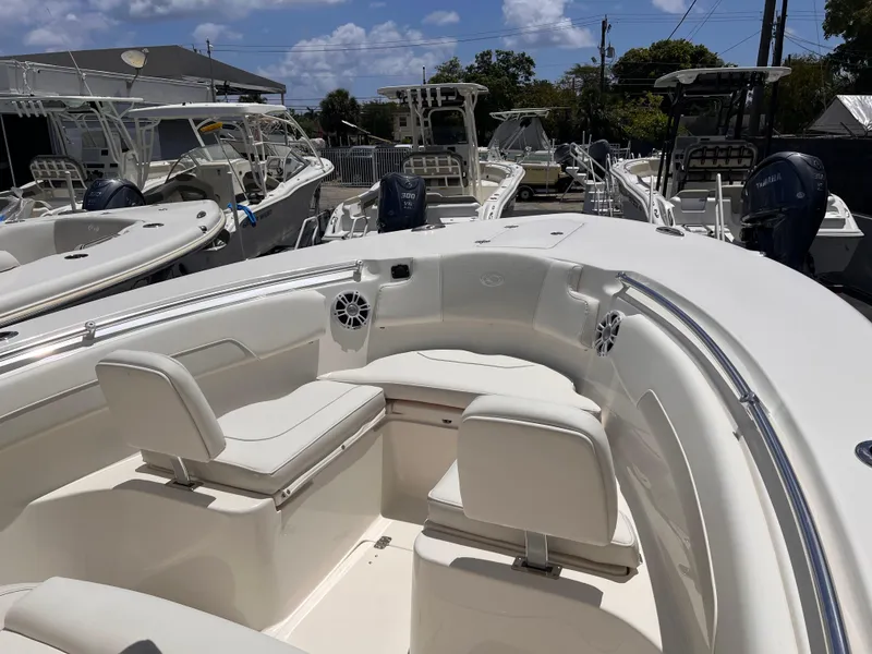 Slide: The Image of 2025 Key West 260 CC boat with spacious seating, docked under a clear sky. - 22