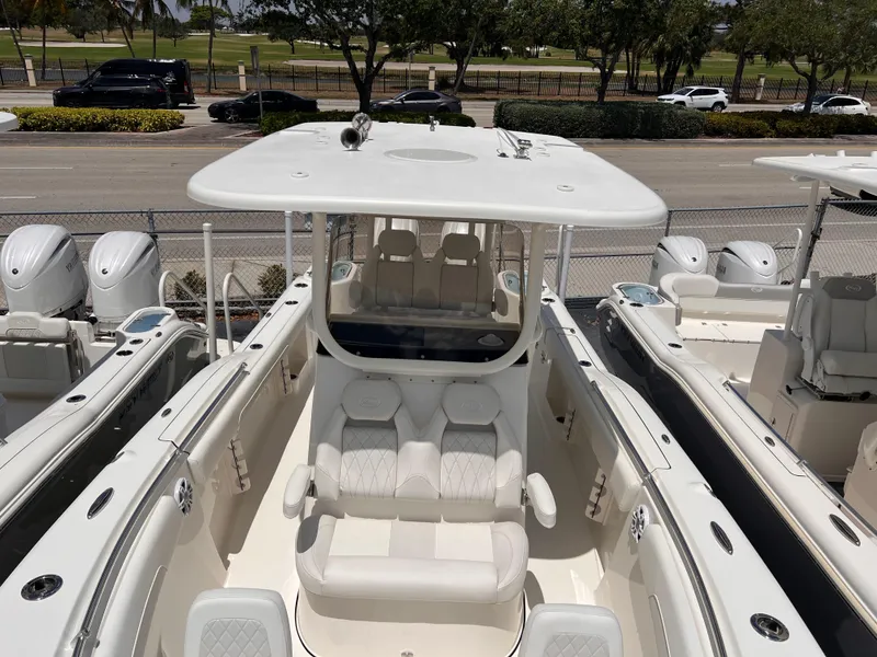 Slide: The Image of 2025 Key West 260 CC boat with spacious seating and sleek design, docked outdoors. - 26
