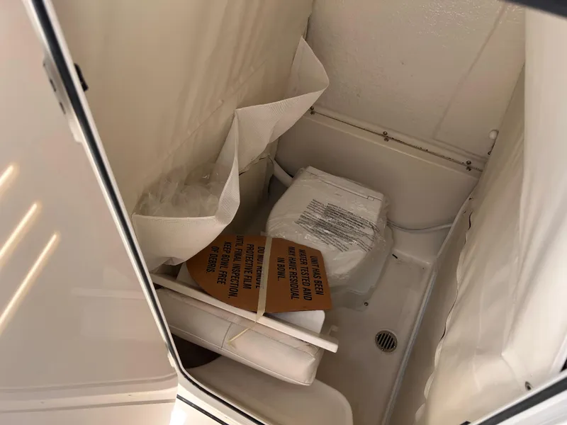 Slide: The Image of 2025 Key West 260 CC boat interior with compact bathroom setup. - 27