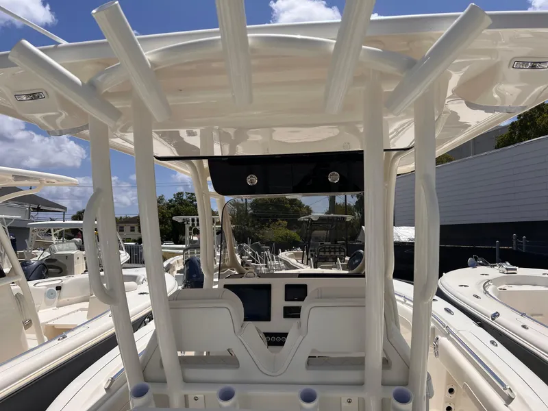 Slide: The Image of 2025 Key West 260 CC boat interior with modern console and seating, under a clear blue sky. - 5