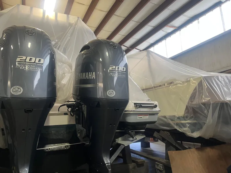 Slide: The Image of 2021 Robalo R272 Center Console with Yamaha 200 engines in storage. - 26