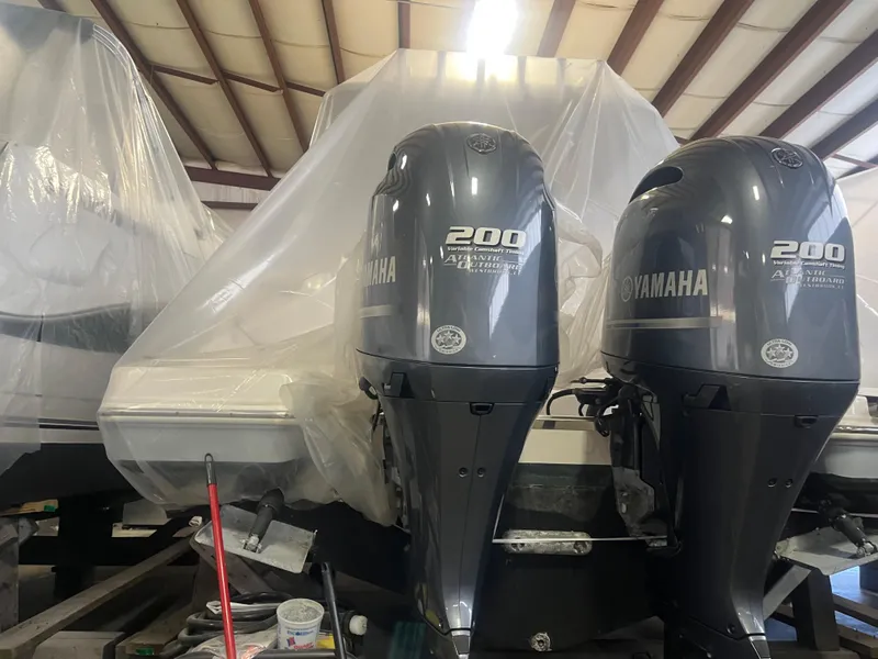 Slide: The Image of 2021 Robalo R272 Center Console with twin Yamaha 200 engines in storage. - 27