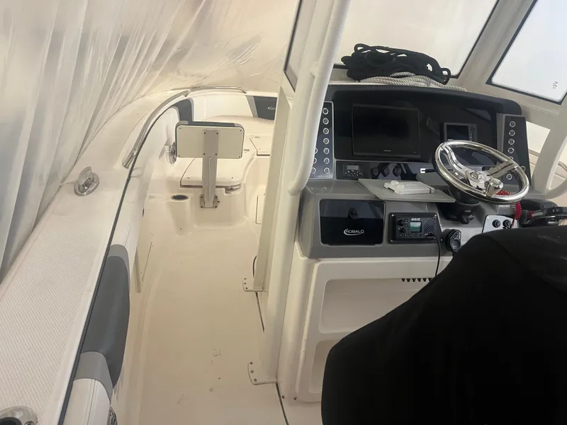 Slide: The Image of 2021 Robalo R272 Center Console boat interior with steering wheel and control panel. - 31