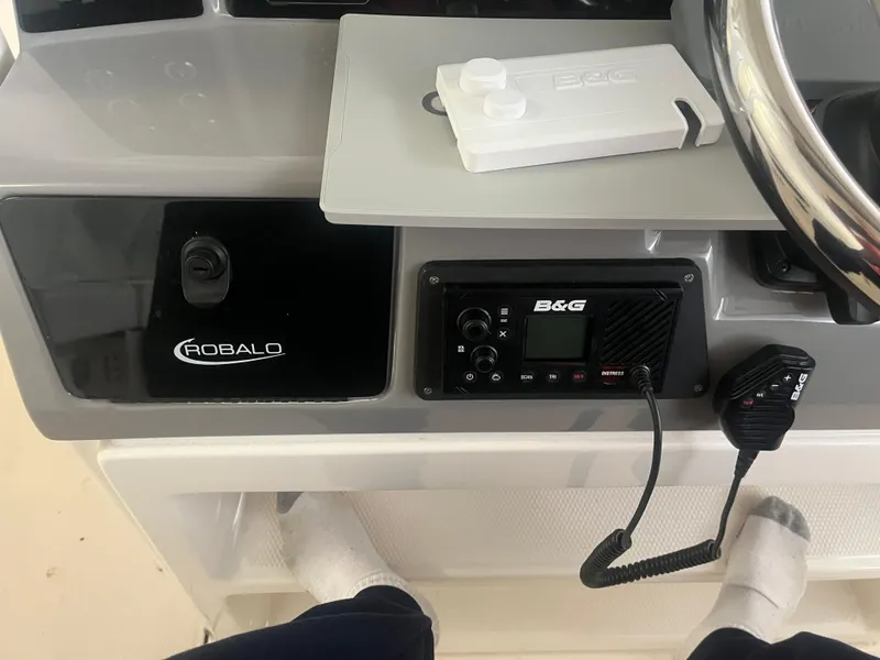 Slide: The Image of 2021 Robalo R272 Center Console dashboard with B&G marine radio and steering wheel. - 32