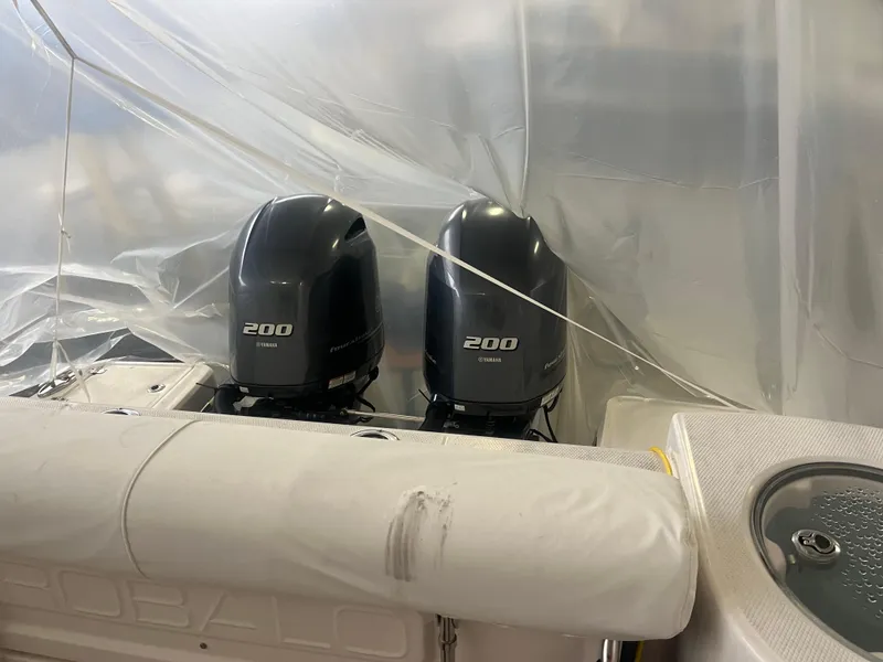 Slide: The Image of 2021 Robalo R272 Center Console with twin 200 HP engines under cover. - 35