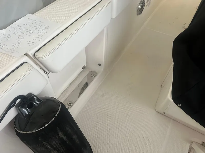 Slide: The Image of 2021 Robalo R272 Center Console interior with white seating and black fender. - 37