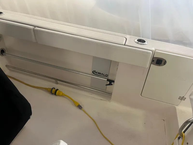 Slide: The Image of 2021 Robalo R272 Center Console boat interior with storage compartment and yellow cable. - 38