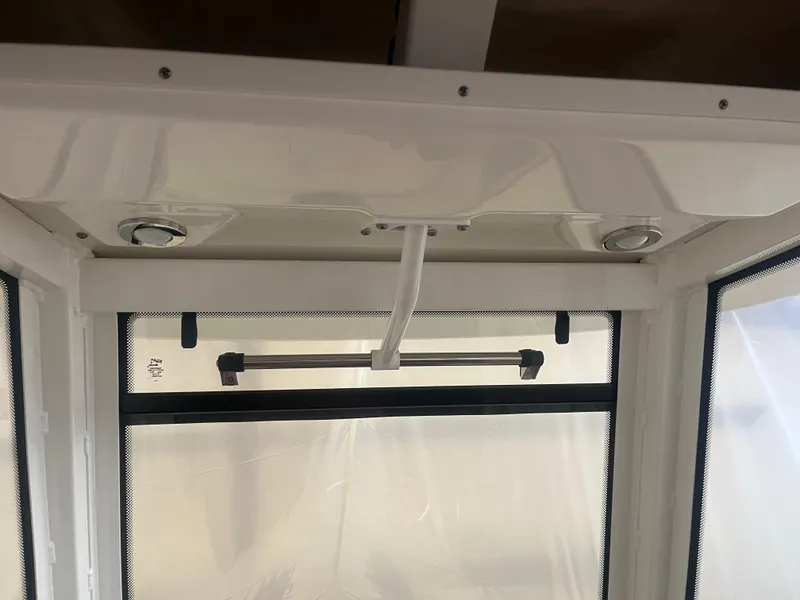 Slide: The Image of Interior view of 2021 Robalo R272 Center Console boat with window and ceiling details. - 40