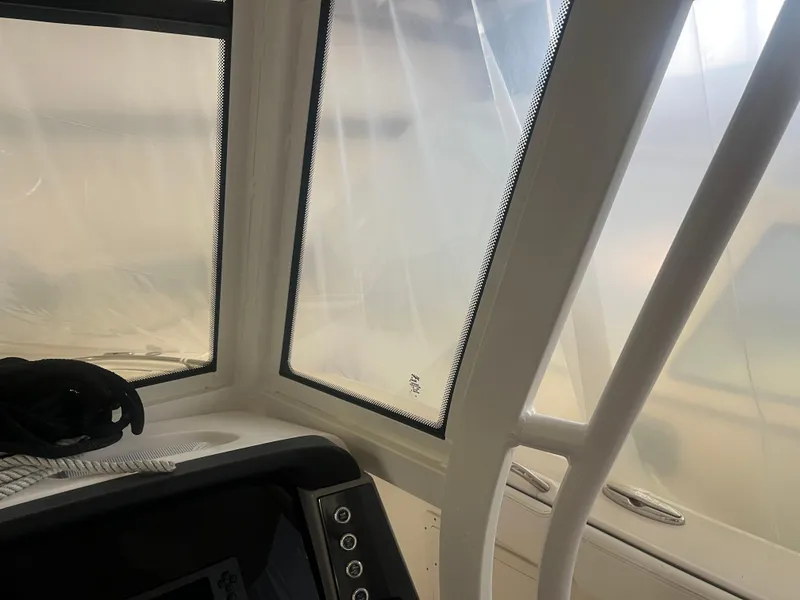 Slide: The Image of 2021 Robalo R272 Center Console interior with protective covering and control panel. - 42