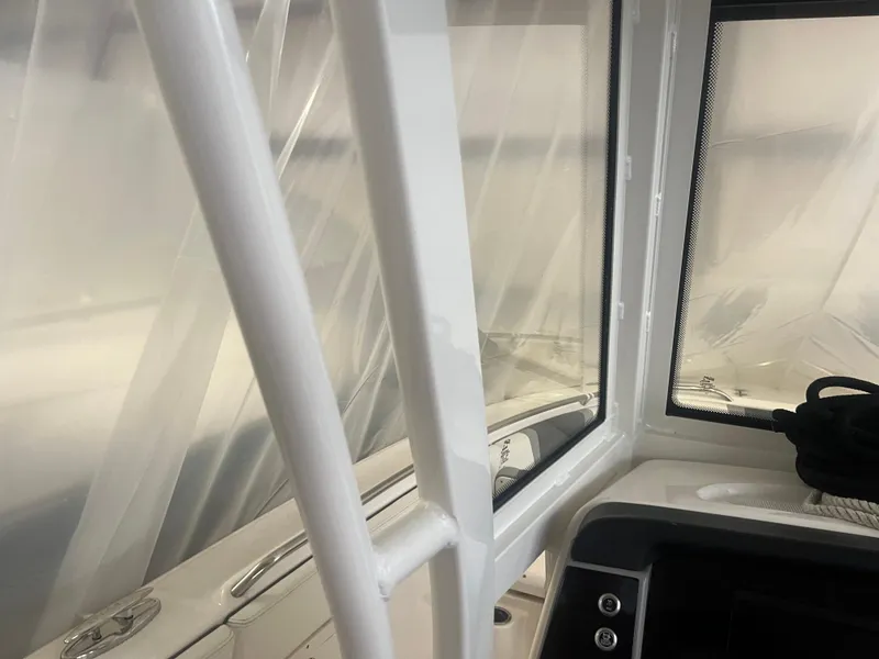 Slide: The Image of 2021 Robalo R272 Center Console interior with window and railing detail. - 43