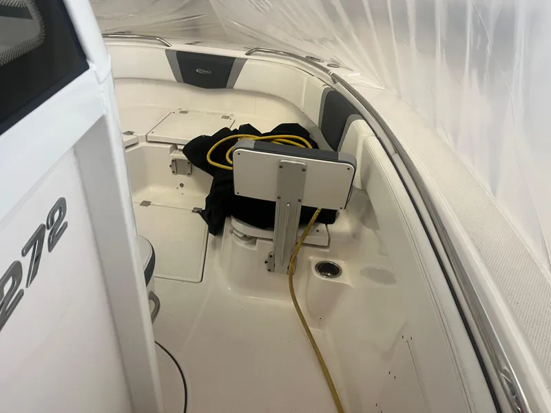 Slide: The Image of 2021 Robalo R272 Center Console boat interior with seating and storage. - 45