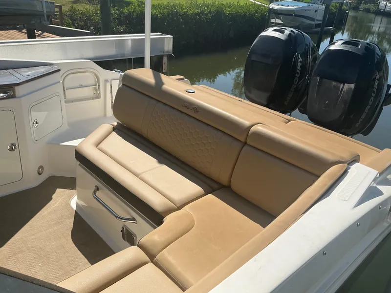 Slide: The Image of 2018 Sea Ray SDX 290 Outboard boat with tan seating and dual engines. - 10