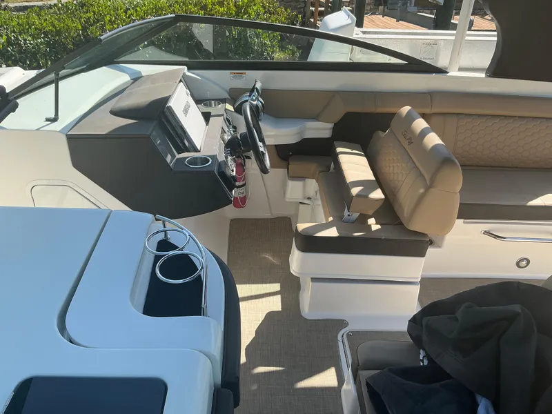 Slide: The Image of 2018 Sea Ray SDX 290 Outboard boat interior with helm, seating, and modern dashboard. - 15