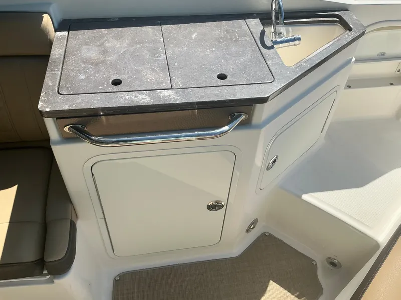 Slide: The Image of 2018 Sea Ray SDX 290 Outboard boat interior with sink and storage area. - 20
