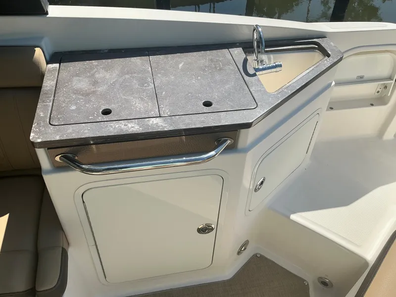 Slide: The Image of 2018 Sea Ray SDX 290 Outboard boat kitchenette with sink and storage. - 21