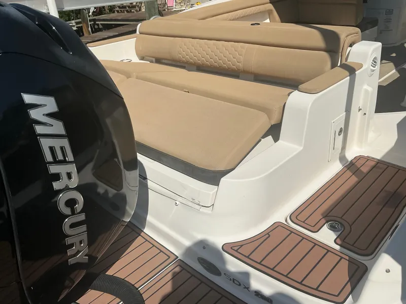 Slide: The Image of 2018 Sea Ray SDX 290 Outboard with Mercury engine, featuring tan seating and teak-style flooring. - 25