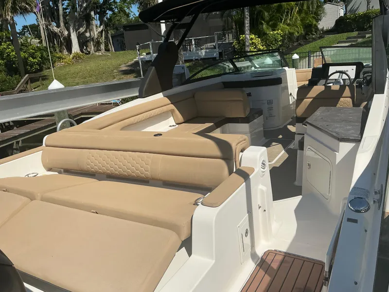 Slide: The Image of 2018 Sea Ray SDX 290 Outboard boat with spacious seating and modern interior design. - 26